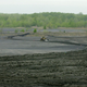 A piece of Koester Contracting’s earth moving equipment moves material Wednesday, April 24, 2002 from the hills of black coal waste byproduct at the processing site outside Lynnville, Indiana.